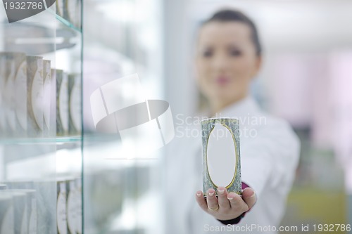 Image of pharmacist chemist woman standing in pharmacy drugstore