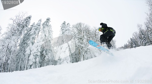 Image of snowboarder on fresh deep snow