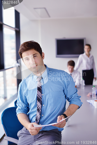 Image of business man  on a meeting in offce with colleagues in backgroun