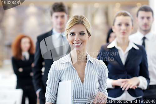 Image of business woman standing with her staff at conference