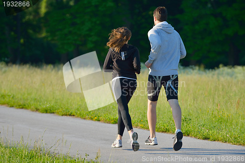 Image of Young couple jogging