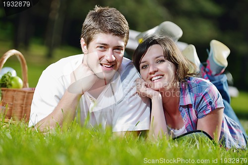 Image of happy young couple having a picnic outdoor