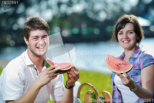 Image of happy young couple having a picnic outdoor