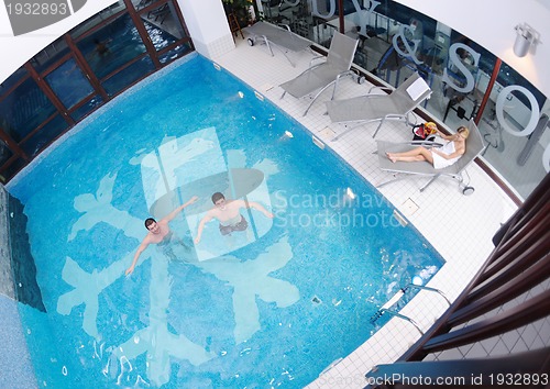 Image of young people group at spa swimming pool