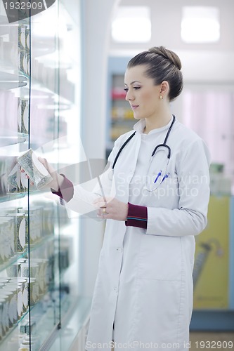 Image of pharmacist chemist woman standing in pharmacy drugstore