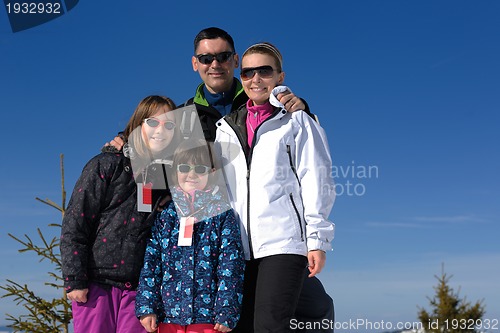 Image of portrait of happy young family at winter
