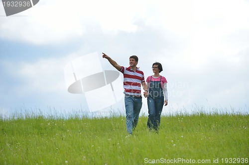 Image of Portrait of romantic young couple smiling together outdoor