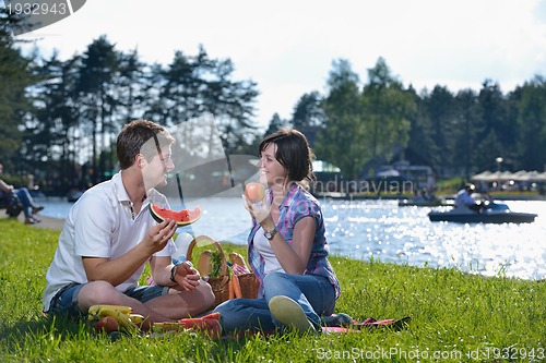 Image of happy young couple having a picnic outdoor