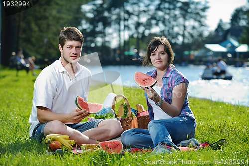Image of happy young couple having a picnic outdoor