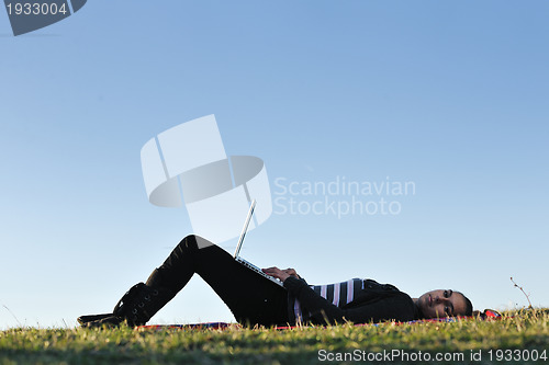 Image of young teen girl work on laptop outdoor