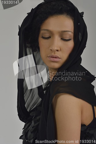 Image of elegant woman in fashionable dress posing in the studio