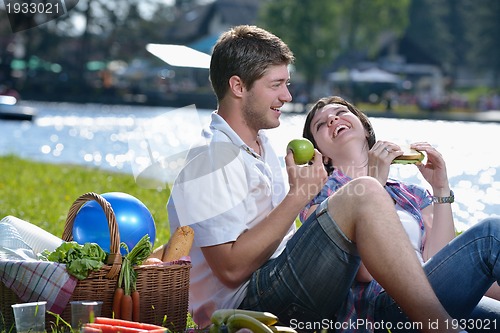 Image of happy young couple having a picnic outdoor
