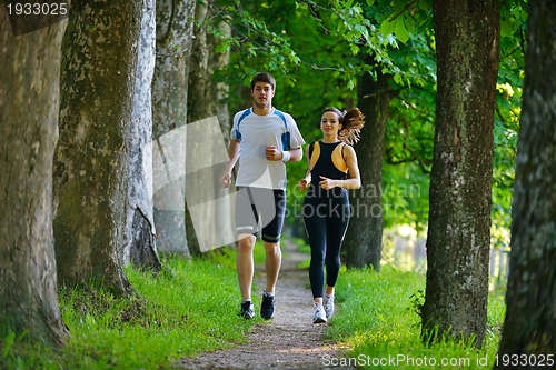 Image of Young couple jogging