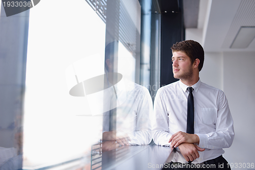 Image of business man  on a meeting in offce with colleagues in backgroun