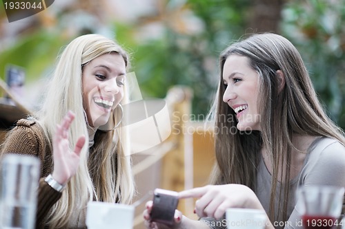 Image of cute smiling women drinking a coffee