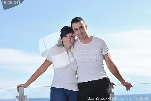 Image of couple relaxing on balcony