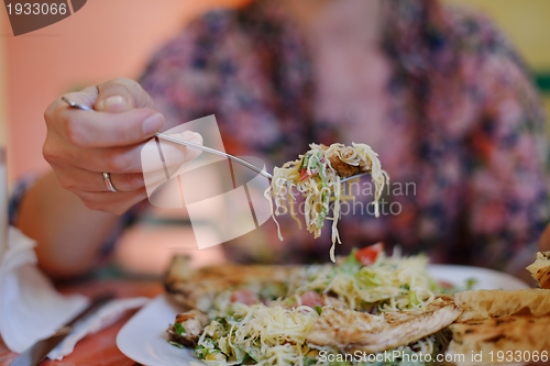 Image of woman eat salad