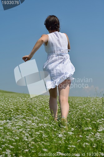 Image of Young happy woman in green field