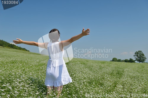 Image of Young happy woman in green field