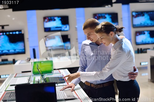 Image of Young couple in consumer electronics store