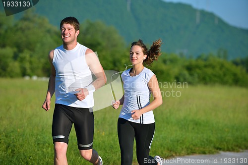 Image of Young couple jogging at morning