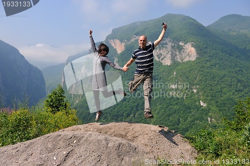 Image of happy young couple jumping in the air