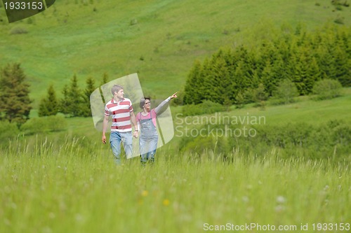 Image of Portrait of romantic young couple smiling together outdoor