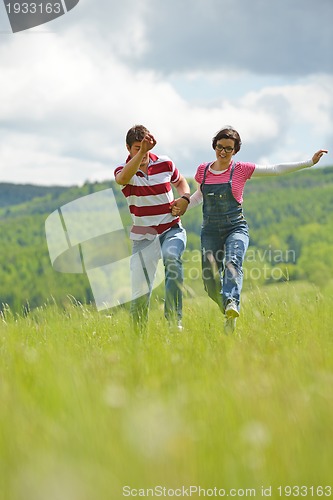 Image of Portrait of romantic young couple smiling together outdoor