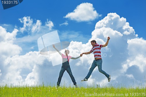 Image of Portrait of romantic young couple smiling together outdoor