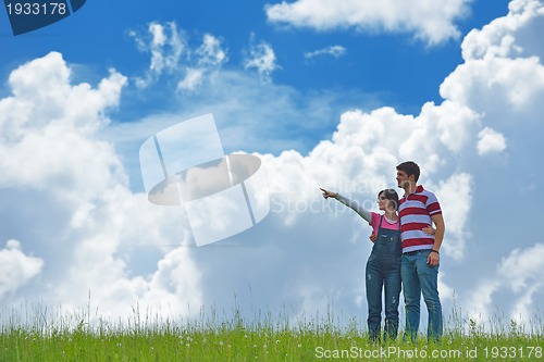 Image of Portrait of romantic young couple smiling together outdoor