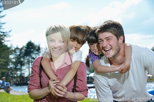 Image of happy young family have fun outdoors