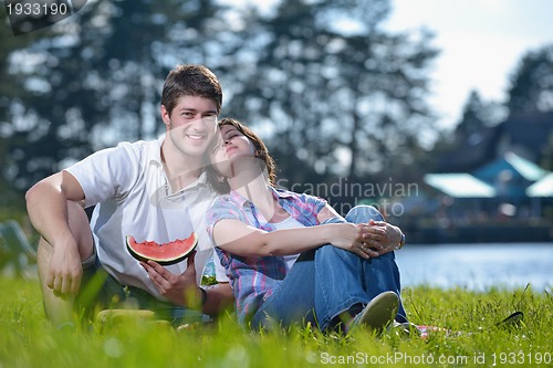 Image of happy young couple having a picnic outdoor