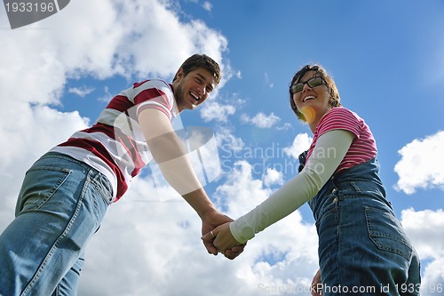 Image of Portrait of romantic young couple smiling together outdoor