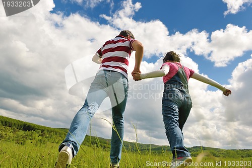 Image of Portrait of romantic young couple smiling together outdoor