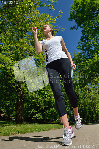 Image of Young beautiful  woman jogging at morning in park