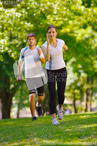 Image of Young couple jogging