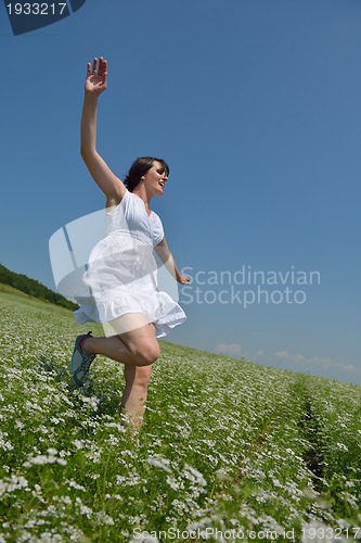 Image of Young happy woman in green field