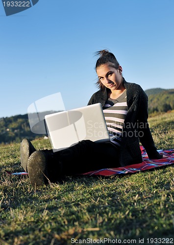 Image of young teen girl work on laptop outdoor