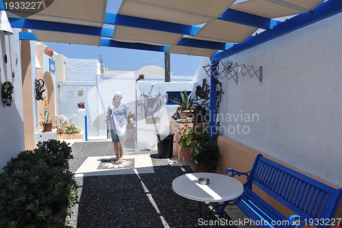 Image of Greek woman on the streets of Oia, Santorini, Greece