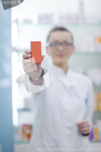 Image of pharmacist chemist woman standing in pharmacy drugstore