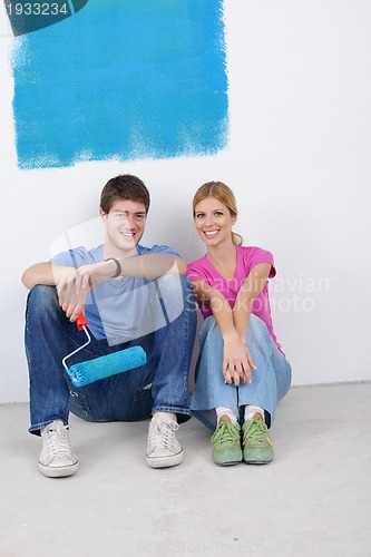 Image of happy young cople relaxing after painting in new home