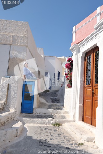 Image of Greek woman on the streets of Oia, Santorini, Greece