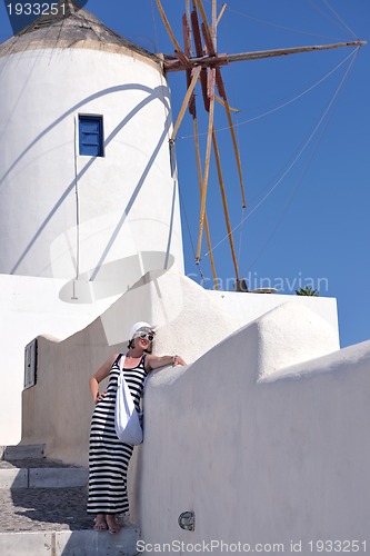 Image of Greek woman on the streets of Oia, Santorini, Greece