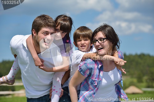 Image of happy young family have fun outdoors