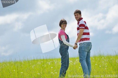 Image of Portrait of romantic young couple smiling together outdoor
