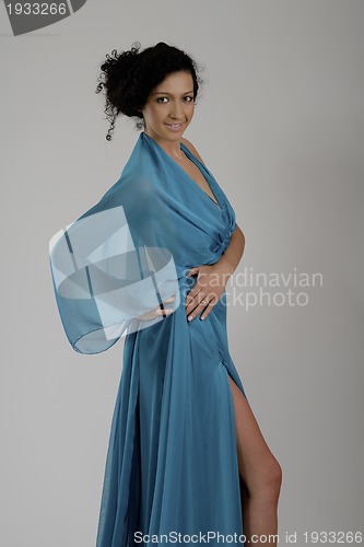 Image of elegant woman in fashionable dress posing in the studio