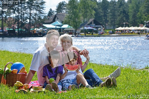 Image of Happy family playing together in a picnic outdoors