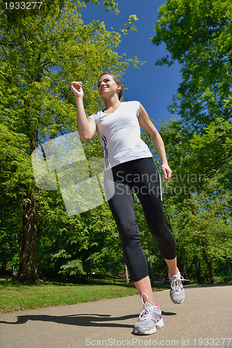 Image of Young beautiful  woman jogging at morning in park