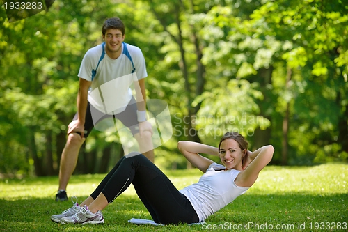 Image of Couple doing stretching exercise  after jogging