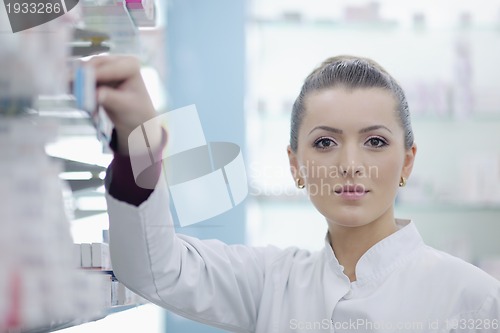 Image of pharmacist chemist woman standing in pharmacy drugstore